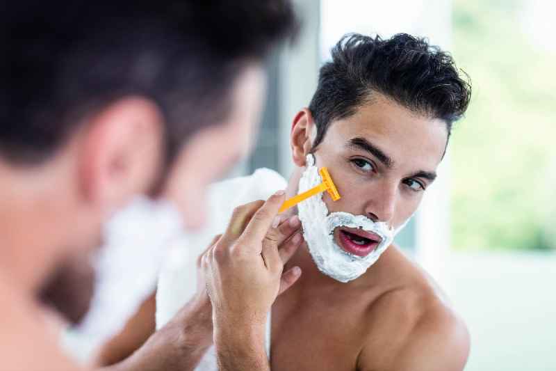 How should a man clean his face