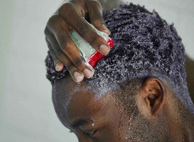 How should Black men use coconut oil for hair
