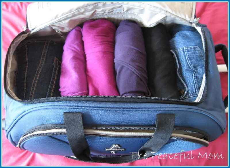 Is it better to fold or roll clothes when packing
