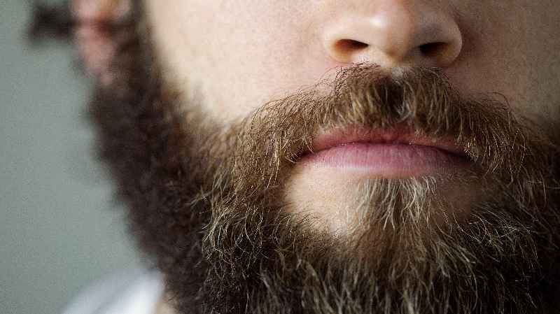What causes a female to have facial hair